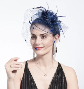 Detail of blue mesh veil fascinator with feathers and matching silver rhinestone earrings