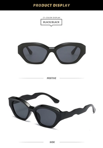 Detail of stylish black square sunglasses with unique wavy temples and high-gloss finish