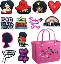Detail of diverse African American themed charms on a pink perforated tote bag