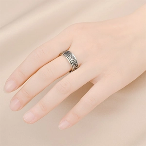 Macro shot of silver Celtic knot spinning ring featuring vintage distressed steel finish