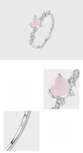 Macro detail of S925 sterling silver stamp and pink heart crystal prong setting