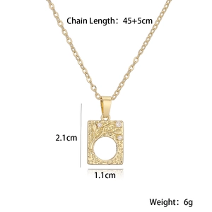 Detail view of gold-plated rectangular pendant necklace with white zircons and relief texture