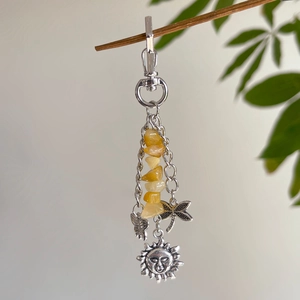 Silver celestial keychain with yellow turquoise stones, sun and butterfly charms on a branch