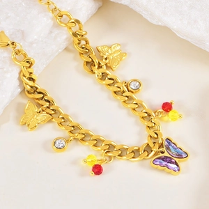 Golden chunky chain bracelet featuring purple crystal butterfly and sparkling rhinestone charms