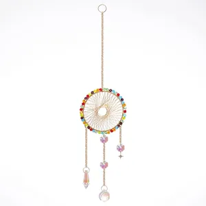 Golden suncatcher dreamcatcher with colorful crystal beads and faceted hanging prisms