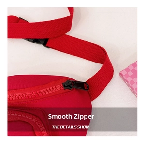 Close-up of smooth red resin zipper and durable woven strap on children cartoon bag