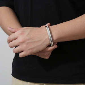 Detail shot of the Roman numeral engraving and pavé set cubic zirconia on the silver bangle