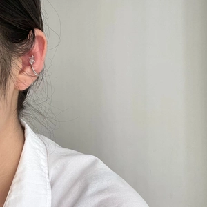 Close-up of minimalist S925 sterling silver ear cuff with square zircon on ear