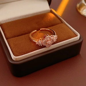 Macro detail of rose gold clover ring with white shell inlay and zircon accents