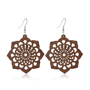 Detailed view of dark brown hollow flower wood earrings with mandala pattern design