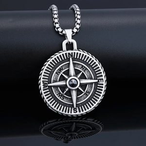 Close-up of silver Viking compass necklace with a faceted black gemstone inlay