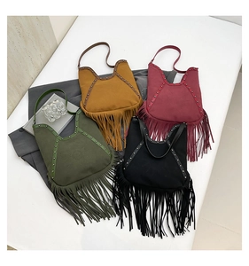 Detailed flat lay of suede fringe shoulder bags with silver studs in four vibrant colors
