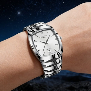 Close-up of silver quartz watch with rectangular dial and date display on wrist
