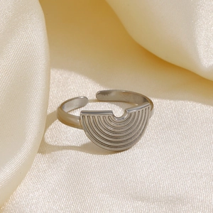 Silver geometric semi-circular stainless steel open ring on champagne silk fabric