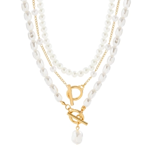 Detail of triple-layer necklace featuring baroque pearls and gold chain with toggle clasps