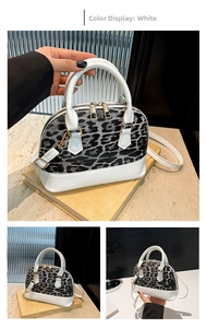 Close-up of shell-shaped crossbody bag featuring white leather and leopard print panels