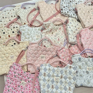 Quilted cotton handbags in pastel colors with floral and cartoon patterns and long straps