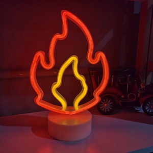 Orange and yellow LED flame neon sign with white base for desktop ambient decoration