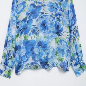 Women's long sleeve bohemian shirt featuring vibrant turquoise floral patterns and buttons