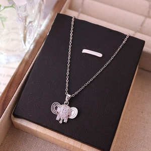 Elegant silver elephant pendant necklace with sparkling cubic zirconia on a jewelry box