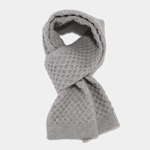 Close-up of gray winter scarf featuring honeycomb knit texture and ribbed edge detail
