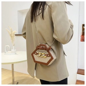 Chic hexagonal woven straw bag with brown leather trim and golden metal chain detail
