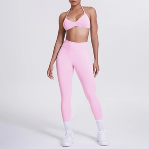 Dettaglio dei leggings yoga rosa a vita alta e reggiseno sportivo sul modello