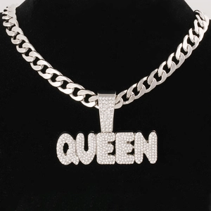Detailed close-up of Queen letter pendant with rhinestones on a silver Cuban link chain