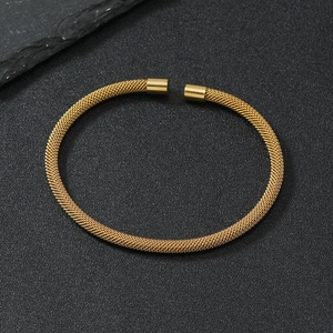 Detailed close-up of golden mesh woven stainless steel open cuff with spiral texture