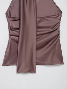 Detail of mauve satin halter top featuring side ruching, invisible zipper and long ties