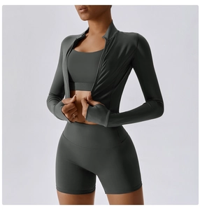 Detail view of charcoal gray three-piece yoga set with thumbholes and high waist shorts