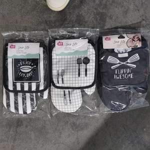 Detailed view of kitchen heat resistant oven mitts and pot pads in various patterns