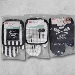 Detailed view of kitchen heat resistant oven mitts and pot pads in various patterns
