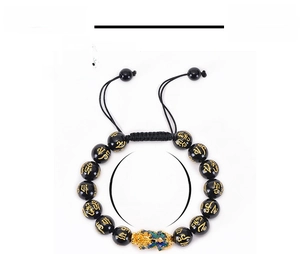 Macro detail of obsidian beads with golden mantra and adjustable braided cord