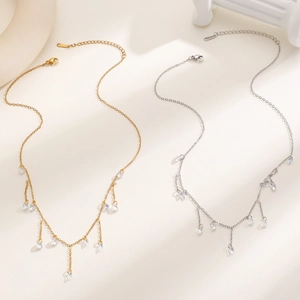 Detailed macro view of 18k gold and silver stainless steel tassel necklaces with sparkling zircons