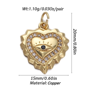 Macro view of evil eye heart pendant in copper with blue stone and white crystals