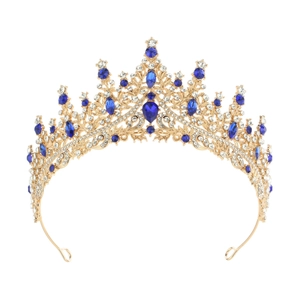 Detail of golden crown with navy blue teardrop gems and white rhinestones on white base