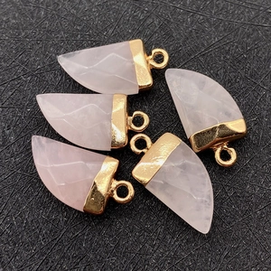 Detail of five rose quartz chili-shaped faceted pendants with gold plated metal caps