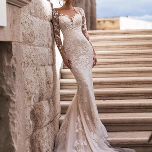 Elegant white lace mermaid wedding dress with long sleeves and illusion V-neck design
