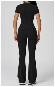 Rear view of black slim-fit yoga set with short-sleeve t-shirt and flare yoga pants