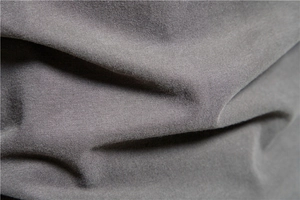 Macro shot of grey cotton knit fabric texture with soft drapes for long sleeve t-shirt