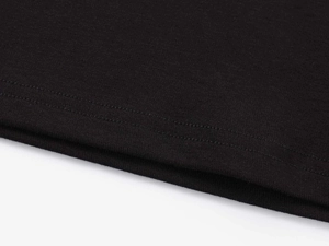 Close-up of double-needle stitching on black modal sports t-shirt hem with fine texture