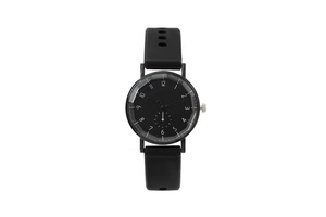 Detailed view of black quartz watch with clear 12-hour numeric markers and silicone strap