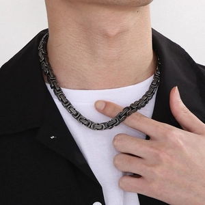 Close-up of a men's vintage silver Byzantine chain necklace in stainless steel on a model