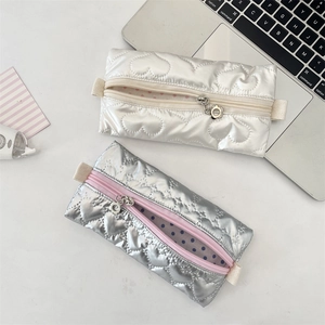 Detail of heart quilted PU pencil cases with polka dot lining and floral zippers