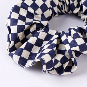 Classic blue and white checkerboard scrunchie made of woven cotton for hair styling