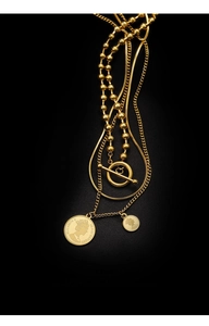 Detailed view of triple-layered gold coin necklace featuring Queen Elizabeth pendant and T-bar clasp