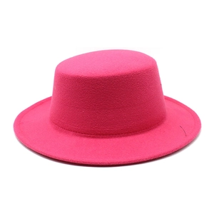 Detail view of the rose pink wool felt flat top fedora with a structured wide brim