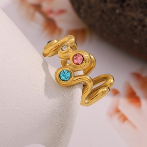 Macro detail of wave-shaped 18K gold-plated ring with inlaid colorful zircon stones
