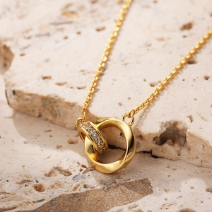 Elegant 18K gold double interlocking Mobius ring necklace with shimmering zircon stones